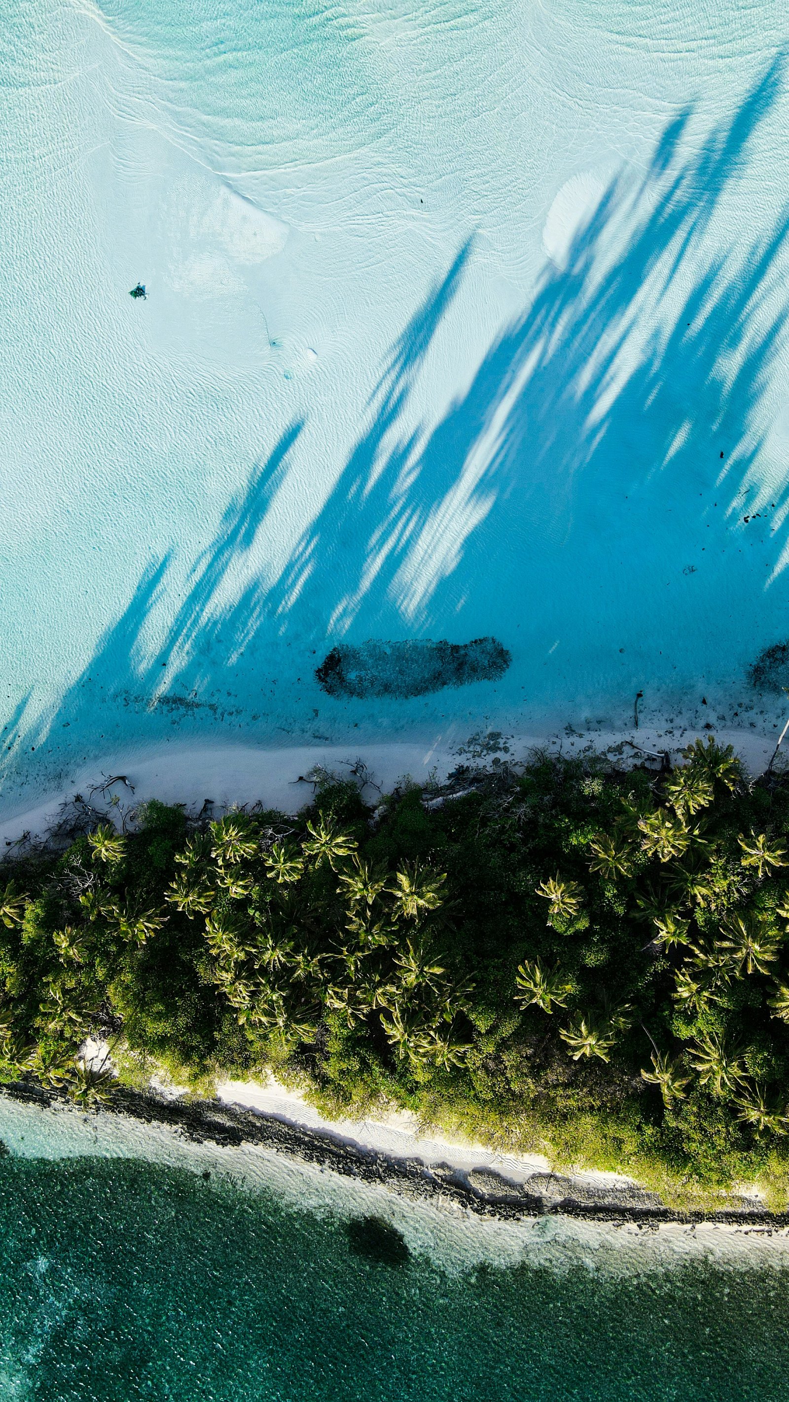 A vivid blue lagoon and island in the Maldives