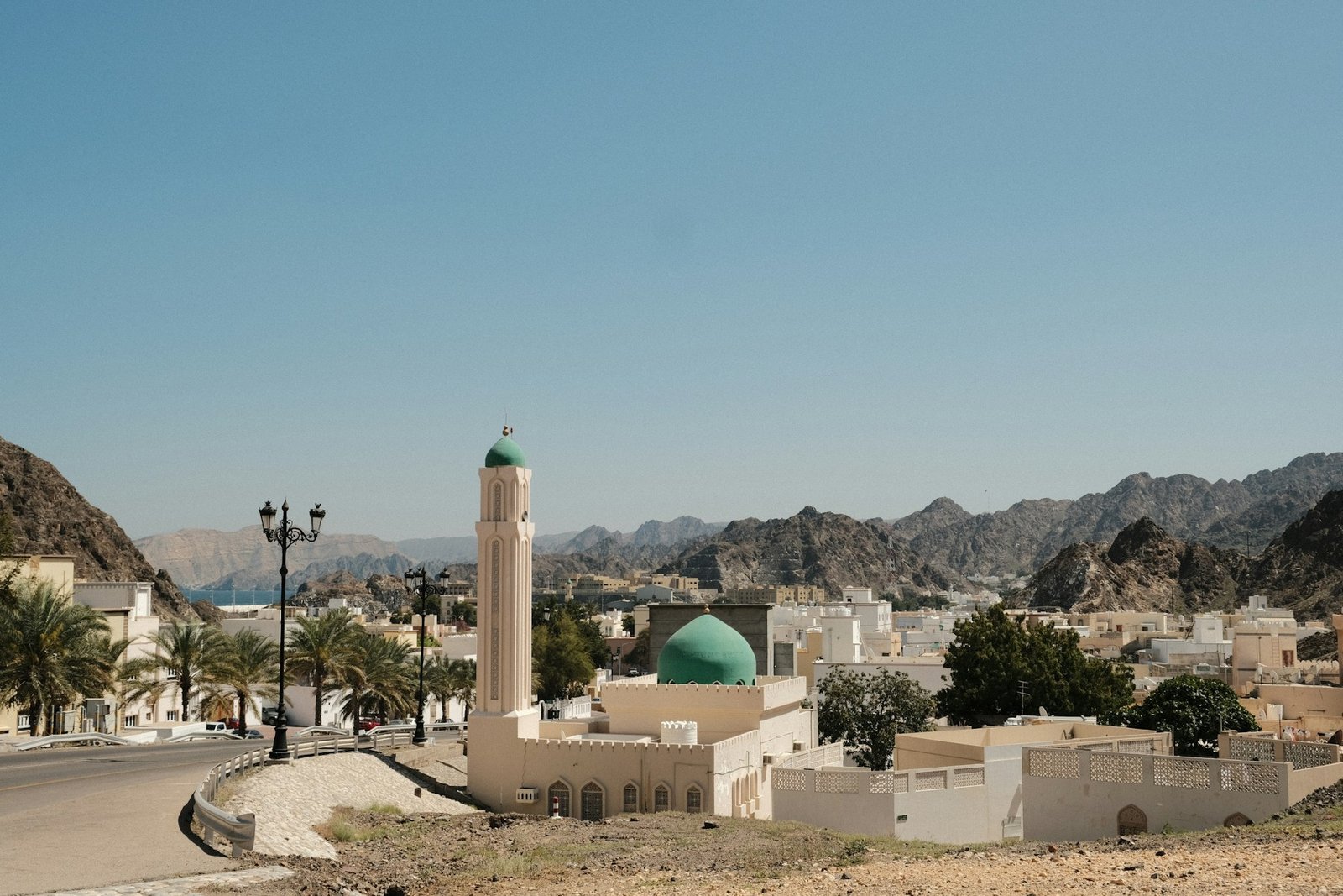 Coastal Muscat with white buildings and rugged mountains in Oman